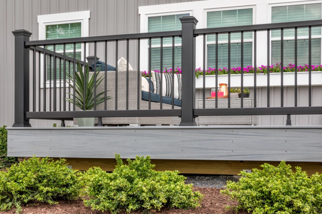 Trex Enhance composite deck railing with black balusters and durable low-maintenance railing system on outdoor deck.
