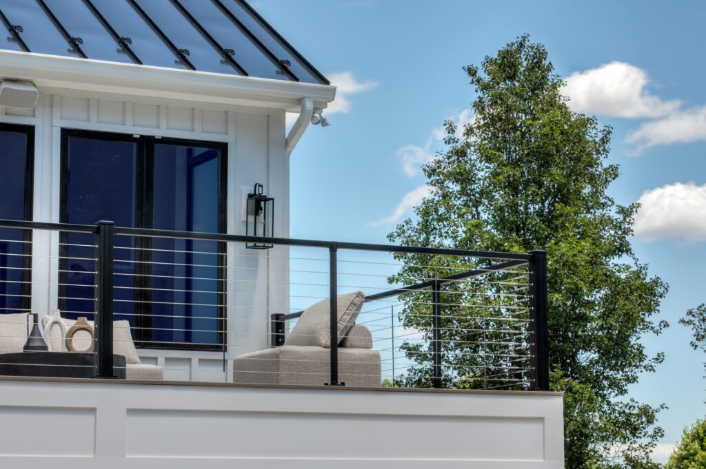 Trex Signature X-Series cable deck railing with horizontal stainless cables and black aluminum posts.