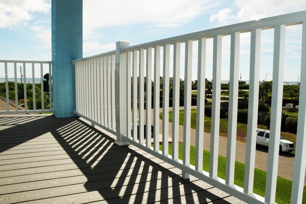 Westbury TRX vinyl railing in white installed on a coastal-style balcony with ocean views, providing a bright and durable railing solution for seaside environments.