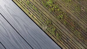 Side-by-side comparison of new composite deck boards next to old moss-covered deteriorating wood decking showing when to repair or replace a deck.