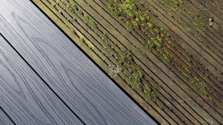 Side-by-side comparison of new composite deck boards next to old moss-covered deteriorating wood decking showing when to repair or replace a deck.