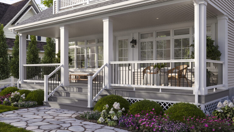 What is a fascia board on a deck — white fascia boards finishing the perimeter of a front porch deck with steps, black metal railing, and landscaped garden beds