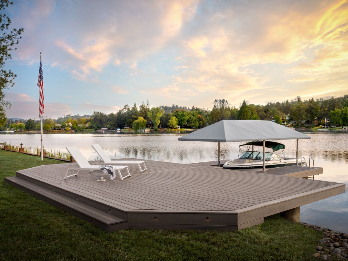 a boat dock with two white composite chairs