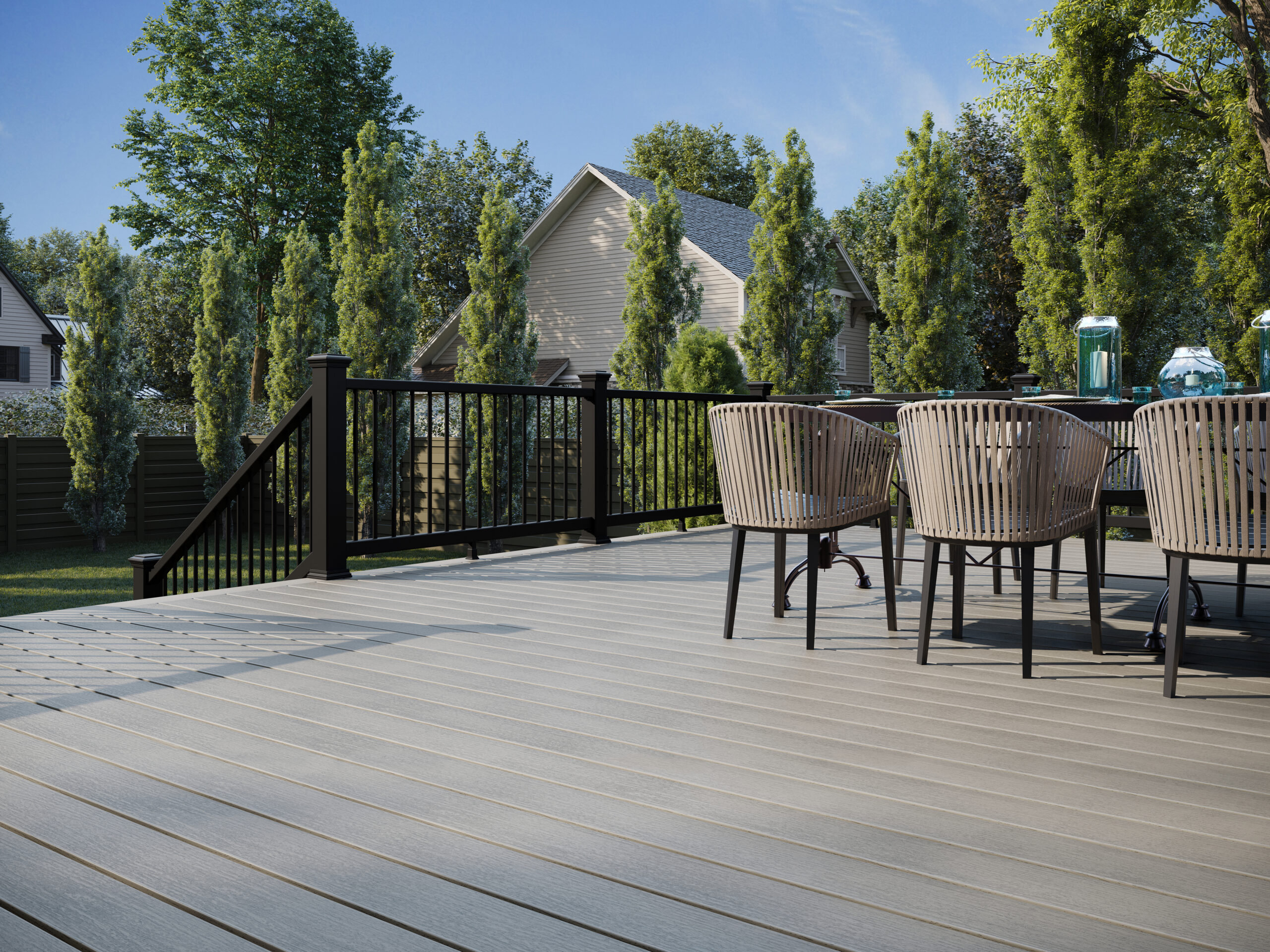 decks vs docks – residential composite deck with black aluminum railing and outdoor dining area