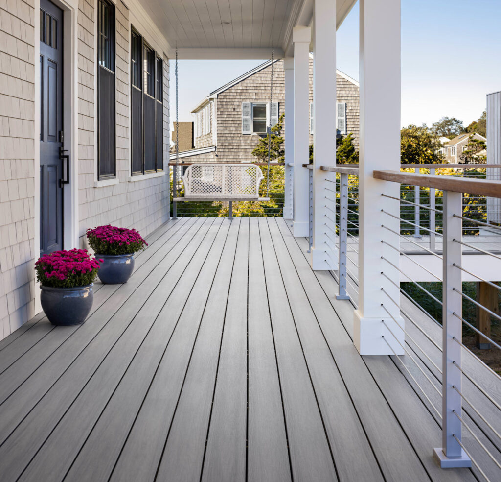 MoistureShield Elevate Alpine Gray composite deck front porch with swing and cable railing