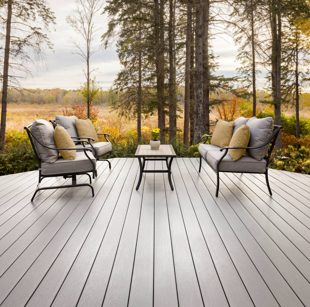 MoistureShield Elevate Lake Fog composite deck with patio seating overlooking autumn forest