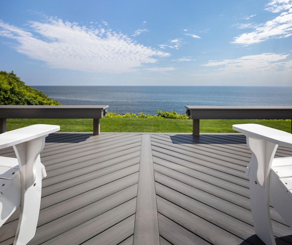 MoistureShield Meridian Citadel composite deck with chevron pattern overlooking ocean and lawn
