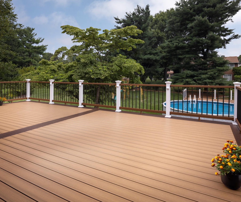 MoistureShield Meridian Shoreside composite deck with railing overlooking pool and backyard trees