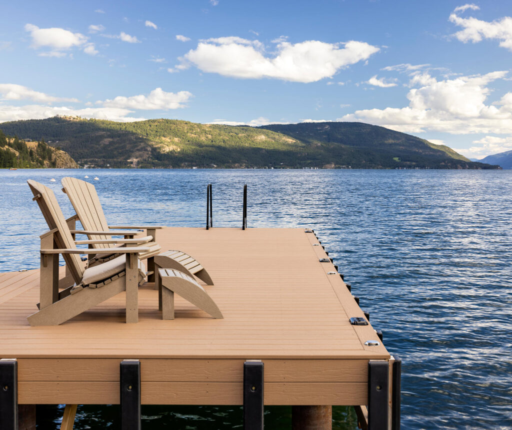 MoistureShield Vantage Bridle uncapped composite dock with Adirondack chairs overlooking lake