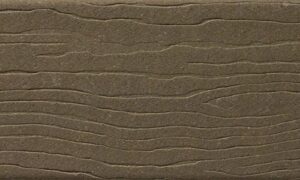 MoistureShield Vantage Earthtone uncapped composite deck board swatch with rustic olive-brown wood grain texture