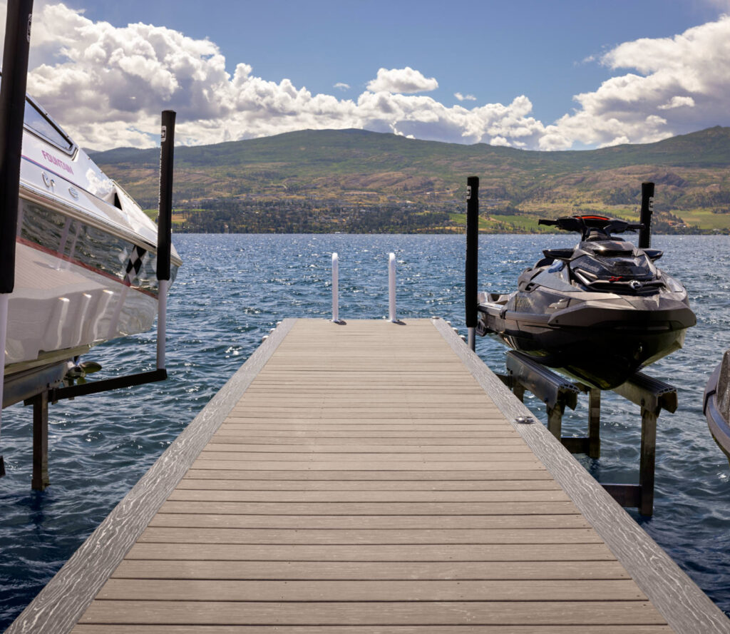 MoistureShield Vision Cathedral Stone composite decking on waterfront dock with boat and jet ski lifts