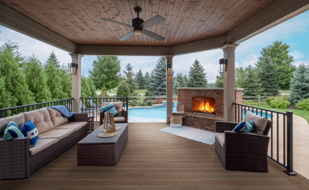 MoistureShield Vision Cold Brew composite deck under covered patio with fireplace and pool view