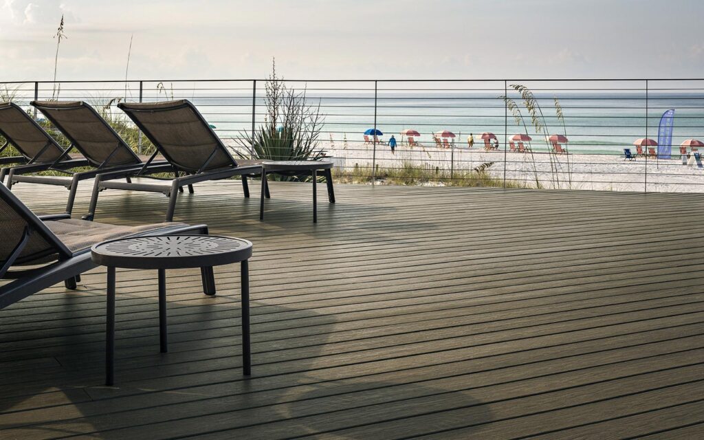 MoistureShield Vision Sandstone composite deck with lounge chairs overlooking beach and ocean
