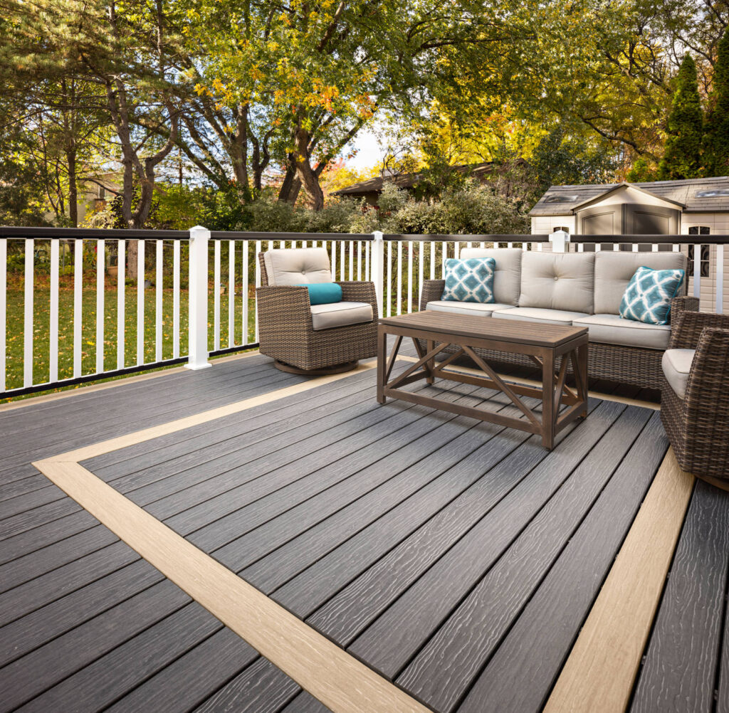 MoistureShield Vision Smokey Gray composite deck with border inlay and wicker patio furniture