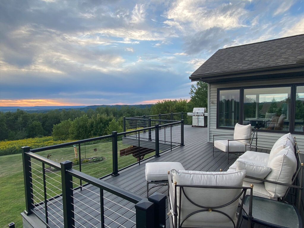AFCO Series 375 black aluminum stair railing with vertical pickets, a classic metal deck railing idea.