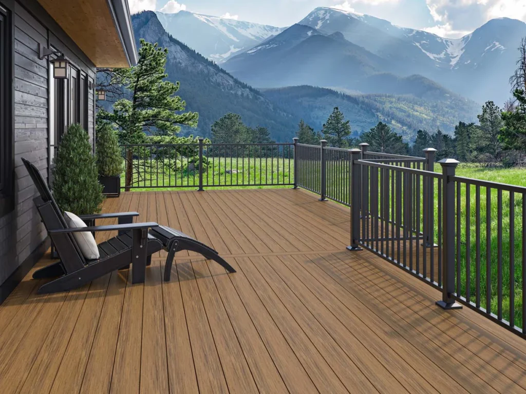 Deckorators composite decking brands in a light tan woodgrain on a mountain-view deck with black aluminum railing