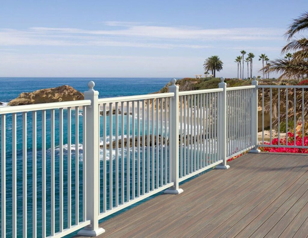 White Fortress AL13 aluminum railing with ball post caps overlooking the ocean.