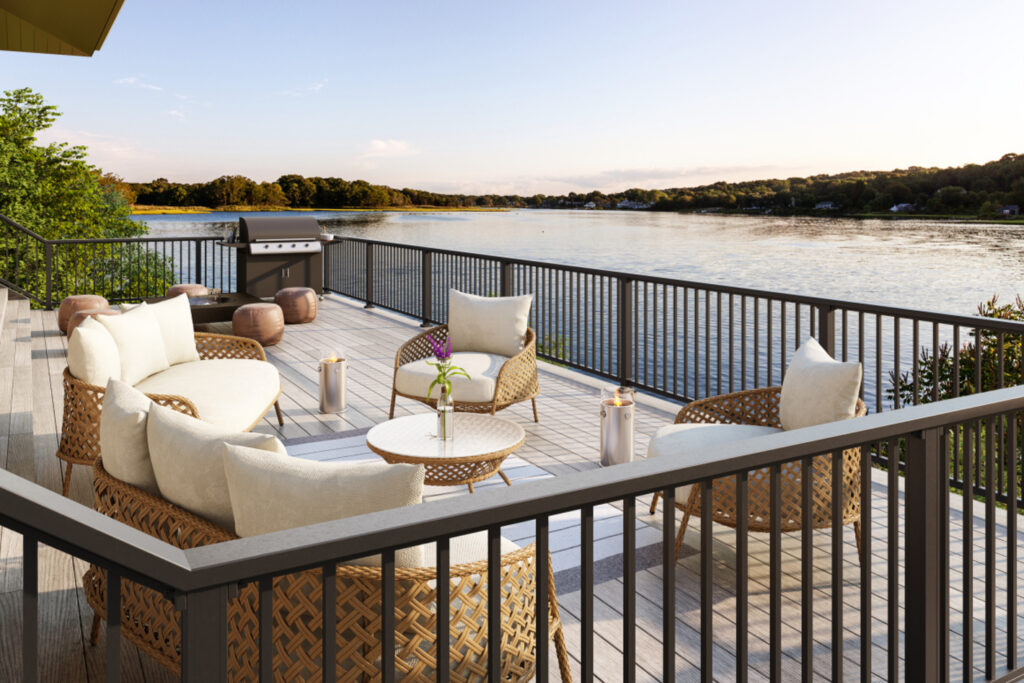 KeyLink Chesapeake aluminum railing with a flat rail cap and square balusters around a gray composite waterfront deck, metal deck railing ideas for lake homes.