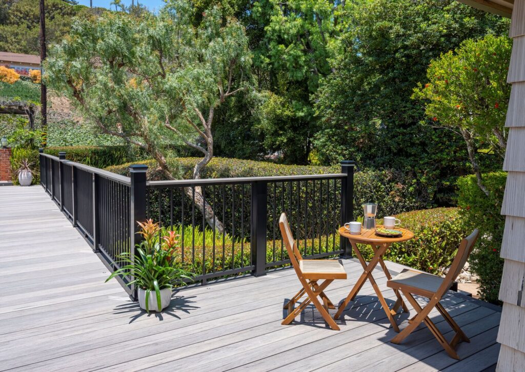 TimberTech Impression Rail Express with an Ashwood drink rail, modern metal deck railing ideas on a gray composite deck.