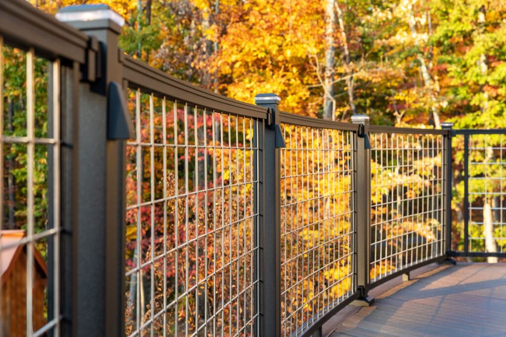 Trex Signature mesh railing panels with post cap lights and fall foliage, textured metal deck railing ideas.