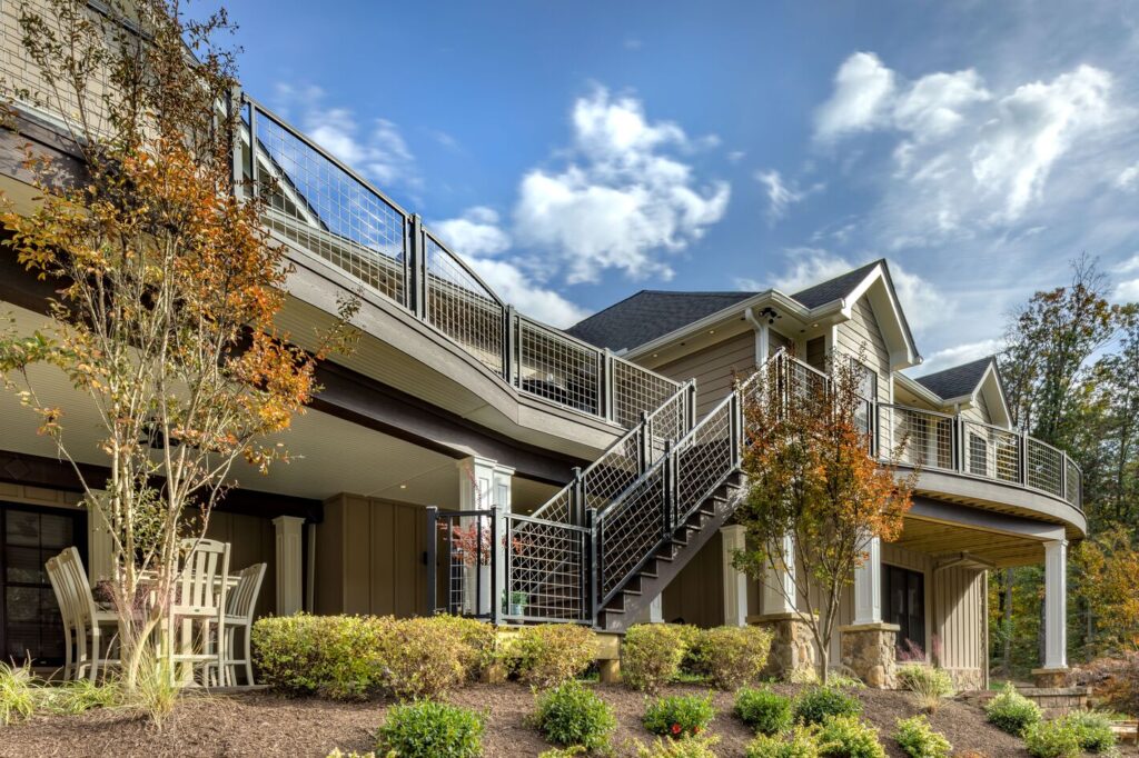Trex Signature mesh railing wrapping a curved two-story deck and stair run.