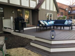 Low-profile composite deck in Wheaton, IL with full-width cascading steps and recessed riser lights.