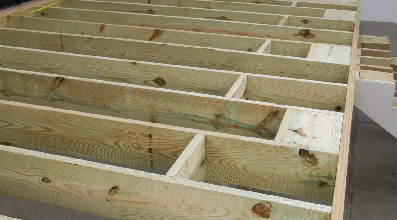 Pressure treated lumber deck frame with joists and blocking
