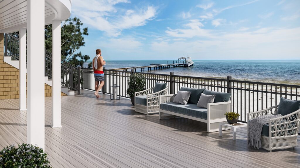 Envision deck ideas featuring Distinction Nantucket Shore decking with dark railing, white columns, coastal seating, and waterfront views.