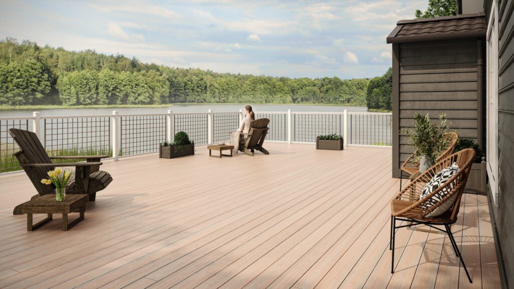 Envision Distinction Seaside Pier deck with white posts, open metal railing, Adirondack chairs, and panoramic lake views.