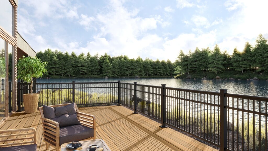 Envision Distinction Spiced Teak lakeside deck with black railing, wood lounge furniture, and peaceful water views.