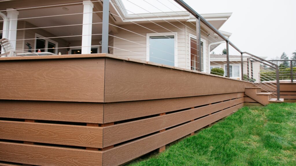 Envision deck ideas featuring EverGrain Weathered Wood decking with horizontal cable railing, matching fascia, and horizontal deck skirting.