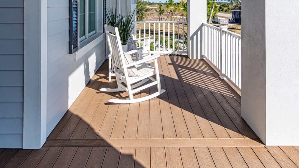 Envision EverGrain Weathered Wood front porch with white railing, white rocking chair, and contrasting board transition.