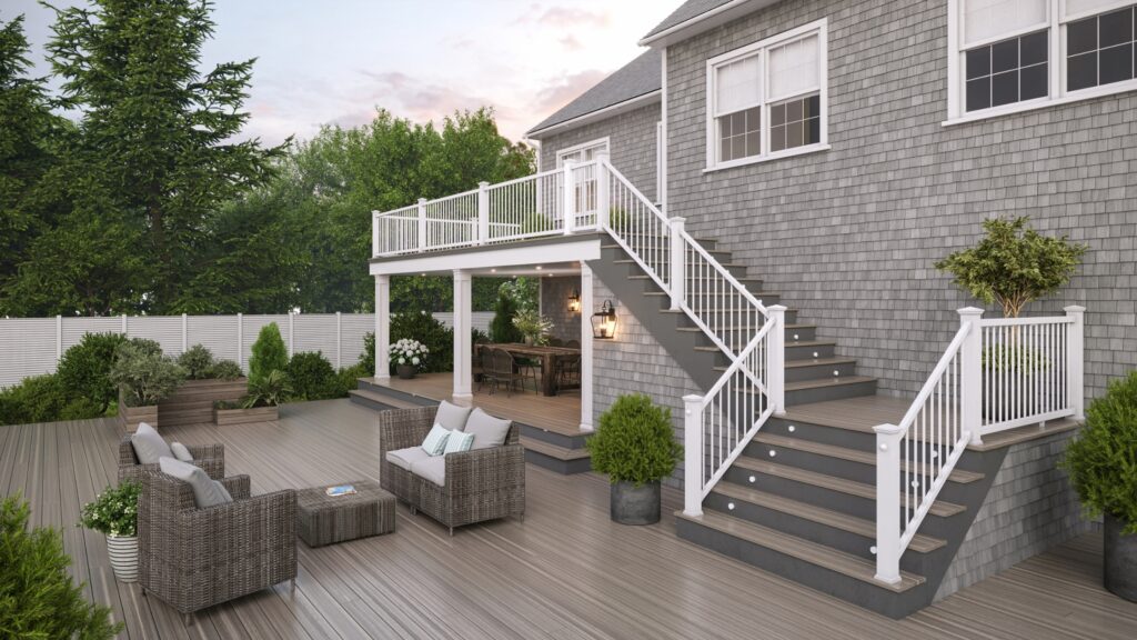 Envision deck ideas featuring Ridge Premium Kodiak Bay on a multilevel deck with white railing, illuminated stairs, lounge seating, and covered dining area.
