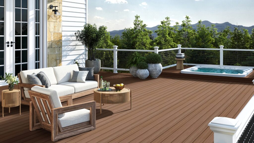 Envision Ridge Premium Sandstone deck with recessed hot tub, white posts, dark grid railing, lounge furniture, and mountain views.