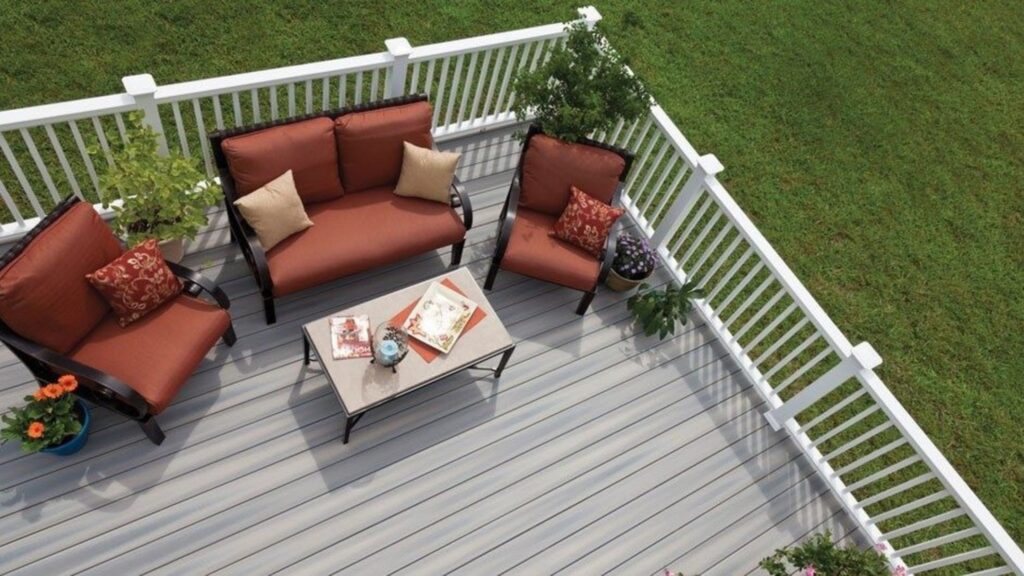 Fiberon ArmorGuard Seaside Gray deck with white railing and outdoor lounge furniture.
