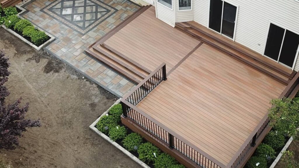 Fiberon Concordia Horizon Ipe multi-level deck with dark picture frame borders and black railing.