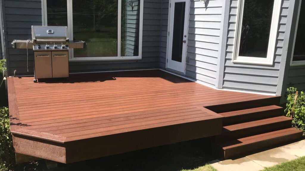 Fiberon deck ideas featuring Concordia Horizon Rosewood Decking with wide stairs and backyard grill.