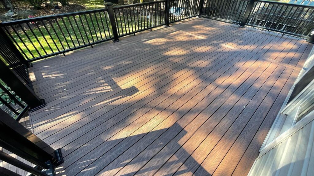 Fiberon Good Life Bungalow deck with black railing and warm brown wood-look boards.