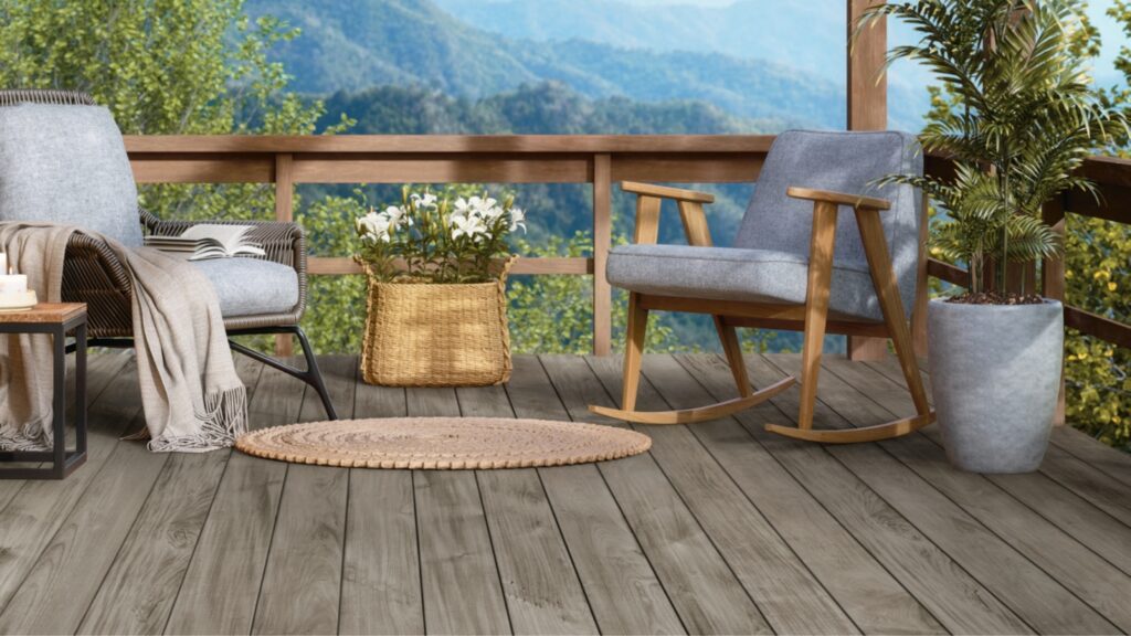 Fiberon Novus Weathered Ipe decking on a mountain-view deck with rocking chairs and wood-toned railing.
