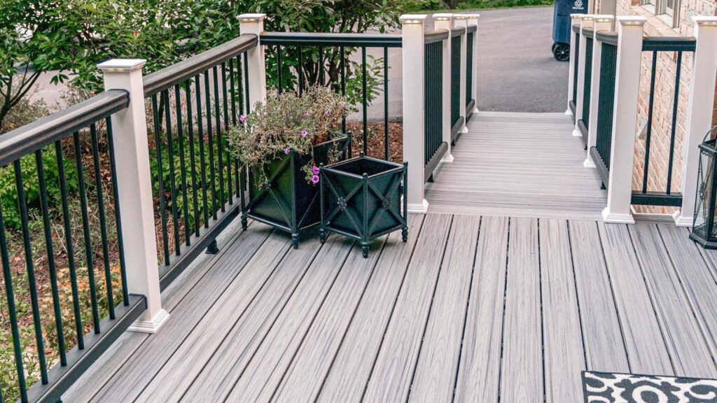 Fiberon deck ideas featuring Sanctuary Latte decking with white posts, black balusters, dark top rails, and walkway.