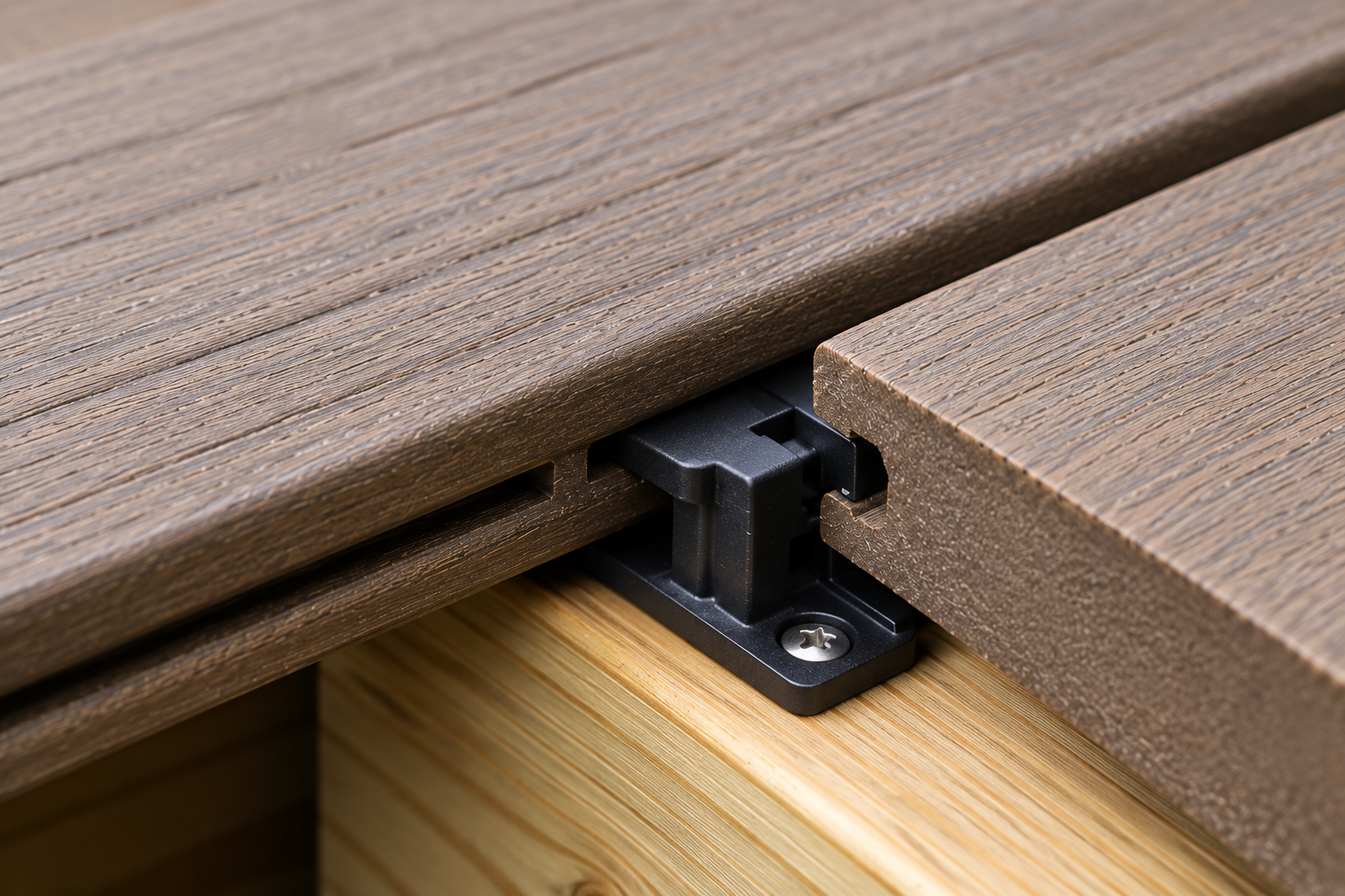 Grooved deck board fasteners securing composite boards with a hidden clip