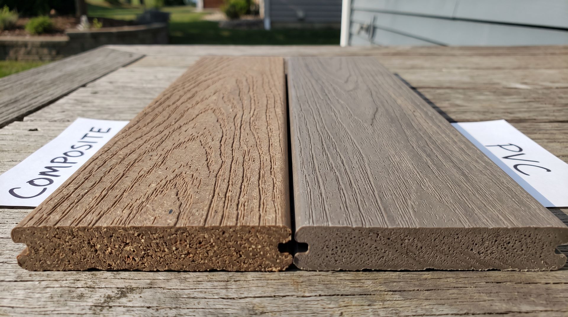 Close-up comparison of composite and PVC deck samples showing different wood grain textures.